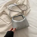 Silver snakeskin pattern mini crossbody bag with gold twist lock and slim shoulder strap - Silver