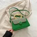 Grass green crossbody bag with woven flap detail and unique gold metal handle - Green