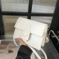 Minimalist white leather square shoulder bag with gold hardware and flap closure - White