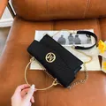 Black vintage crossbody bag with woven texture lid and golden circular handle - Black