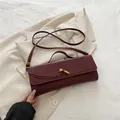 Elegant wine red crocodile pattern baguette bag with a stylish gold buckle and handle - Red