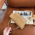 Light brown woven leather handbag with a gold metal ring handle and chain strap - Khaki