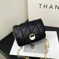 Quilted black faux leather chain bag with a round gold buckle and minimalist strap - Black