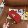 Chic red rectangular shoulder bag with woven texture, golden handle and M logo - Red