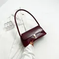 Glossy burgundy patent leather underarm bag with elegant gold buckle and shoulder strap - Burgundy