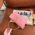 Pink crocodile pattern handbag with gold metal handle and chain shoulder strap - Pink