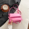 Fashionable bright pink rectangular leather crossbody bag with adjustable strap and metal buckles - Pink
