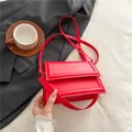 Chic red rectangular faux leather crossbody bag with elegant gold-tone hardware and strap - Red
