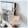 Creamy white shoulder bag with silk scarf wrapped chain and elegant bow detail - Off White