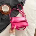 Bright pink PU leather mini square bag with top handle and crossbody strap in a flat lay view - Rose Red