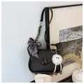 Minimalist black matte shoulder bag featuring geometric silk scarf and plush charm - Black With Rabbit Pendant