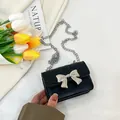 Classic black mini crossbody bag with a silver metallic bow and chain strap for girls - Black