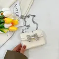 Mini cream crossbody bag with silver bow accent and metal chain for young girls - Off White