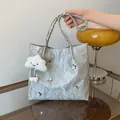 Zilveren metallic tote tas met vlinderdetails, gevlochten handvatten en wolkbedeltje - Zilver Met Hanger