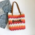 Woven straw summer tote with colorful stripes and Summer embroidery on white background - Orange Red