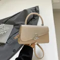 Sac bandoulière beige chic avec rabat scintillant et fermoir cœur en décor urbain - Doré