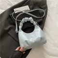 Light blue faux leather half-moon shoulder bag with unique pleated cloud handle - Blue