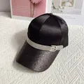 Close-up of black satin baseball cap featuring glitter brim and rhinestone buckle strap - Black