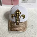 Detail of fleur-de-lis gold rhinestone emblem on white canvas denim baseball cap - Adult Adjustable / White