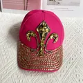Close-up of rose pink denim hat with golden fleur-de-lis and rhinestone brim details - Adult Adjustable / Rose Red