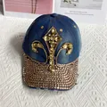 Close-up of golden rhinestones and iris flower embroidery on a denim baseball cap - Adult Adjustable / Dark Blue Denim