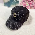 Dettaglio del berretto da baseball nero con strass colorati e logo C in metallo dorato - Diamanti Neri Di Colore Ab Con Marchio C / Adulto, Regolabile