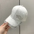 Dettaglio di berretto in pizzo bianco con farfalla di strass e bordo con brillantini - Taglia Adulto (Regolabile) / Bianco Sporco