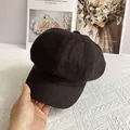 Detail of a black linen newsboy cap with structured brim and soft fabric texture - L / Black