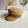 Detail view of the khaki cotton linen newsboy cap with vintage brown faux leather belt buckle - One Size / Khaki