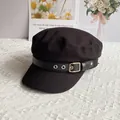 Detail of a vintage black baker boy hat featuring a leather strap and silver buckle - One Size / Black