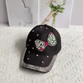 Detail of a black denim baseball cap with a large rhinestone bow and scattered crystals - Bow / Black