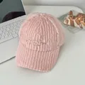 Close-up of pink fuzzy baseball cap with golden embroidery and plush ribbed texture - Adjustable / Pink