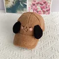 Close-up of the plush lamb wool texture and cute embroidered puppy face on the baseball cap - Adjustable / Caramel color