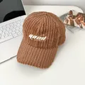 Close-up of brown plush texture baseball cap with GOOD embroidery on a cozy desk - Adjustable / Coffee (GOOD FRIENDLY)