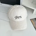 Close-up of white fleece baseball cap featuring dark Balance embroidery and soft texture - Adjustable / White
