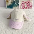Detail view of pink rabbit ears and Sparkle embroidery on a plush lamb wool baseball cap - Adult / White + Purple