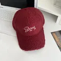 Close-up of burgundy sherpa baseball cap featuring white Balance embroidery and butterfly - Adjustable / Burgundy