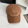 Detailed view of brown sherpa baseball cap with Balance embroidery on a modern desk - Adjustable / Caramel color
