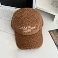 Close-up of winter brown sherpa baseball cap featuring white Mild Buck embroidery detail - Adjustable / Caramel color