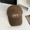 Detailed texture of brown fleece baseball cap with white Balance embroidery on white table - Adjustable / Coffee