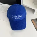 Detail of blue lamb wool baseball cap with white 'Mild Back' letter embroidery - Adjustable / Blue