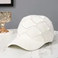 Macro detail of white knit baseball cap featuring rhinestone studs and quilted pattern - Adult Size (Adjustable) / White
