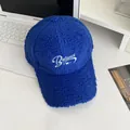 Detail of Klein blue sherpa baseball cap with white Balance embroidery on a laptop - Adjustable / Blue