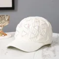 White knit baseball cap with rhinestone triangle pattern for winter warmth and style - Adult / White