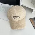 Close-up of beige teddy fleece baseball cap with Balance embroidery and soft texture - Adjustable / Beige