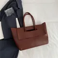 Minimalist large-capacity dark burgundy leather tote bag with elegant wing-shape design - Coffee