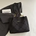 Chic black tote bag featuring diamond texture, leather strap, and gold chain accents - Black