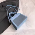 Light blue leather crossbody pillow bag with contrast stitching and golden hardware - Blue