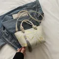 Chic beige bucket bag with gold bamboo leaf print and silk tassel on blue denim jacket - Khaki