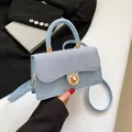 Light blue crossbody bag with denim texture flap and golden round metal lock - Blue